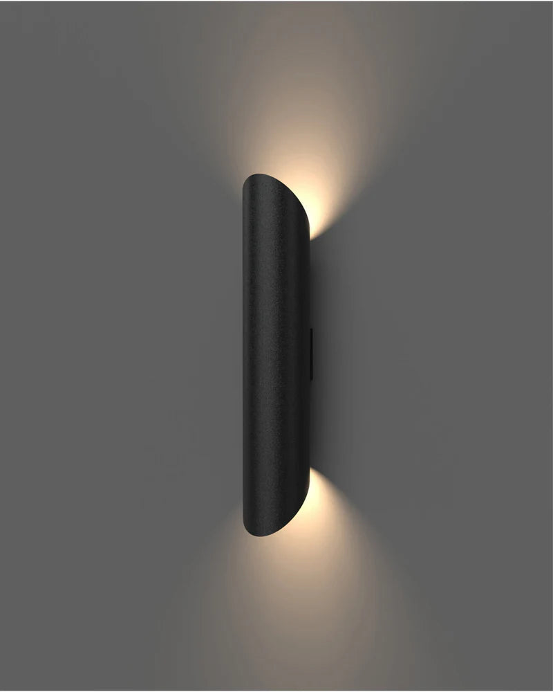 Black wall-mounted light fixture on a gray background